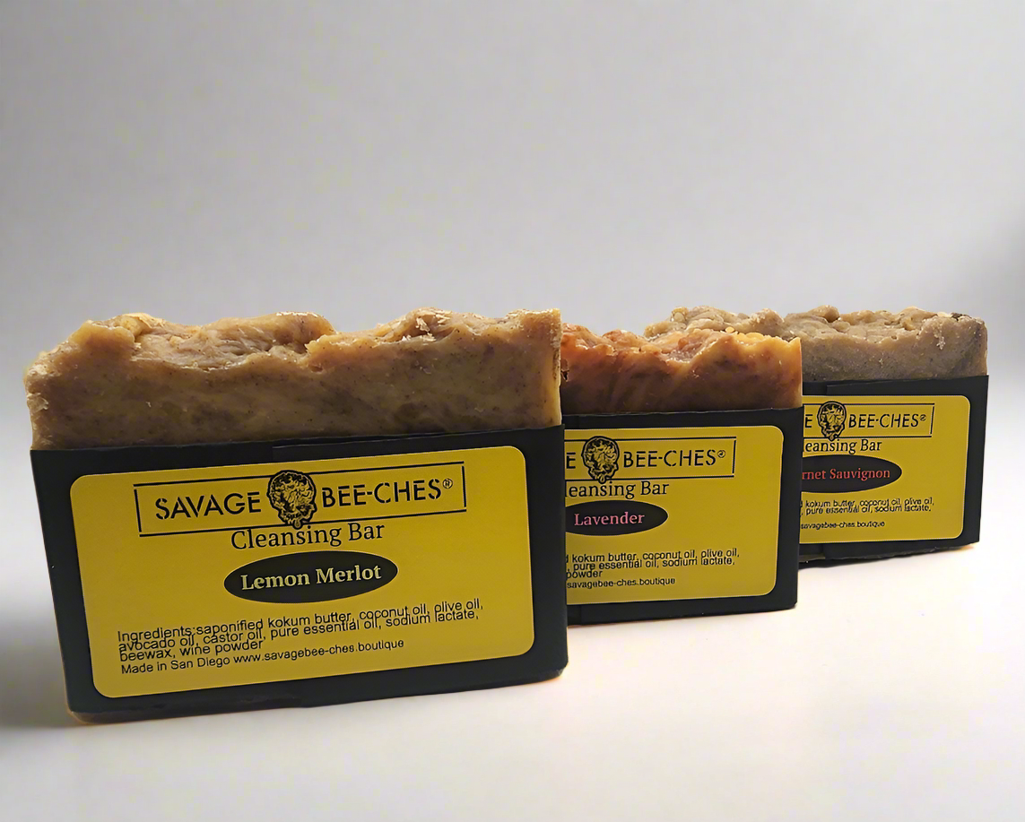 Three handcrafted SAVAGE BEE-CHES Beeswax Cleansing Bars: Lemon Merlot, Lavender, and Cabernet Sauvignon in San Diego.