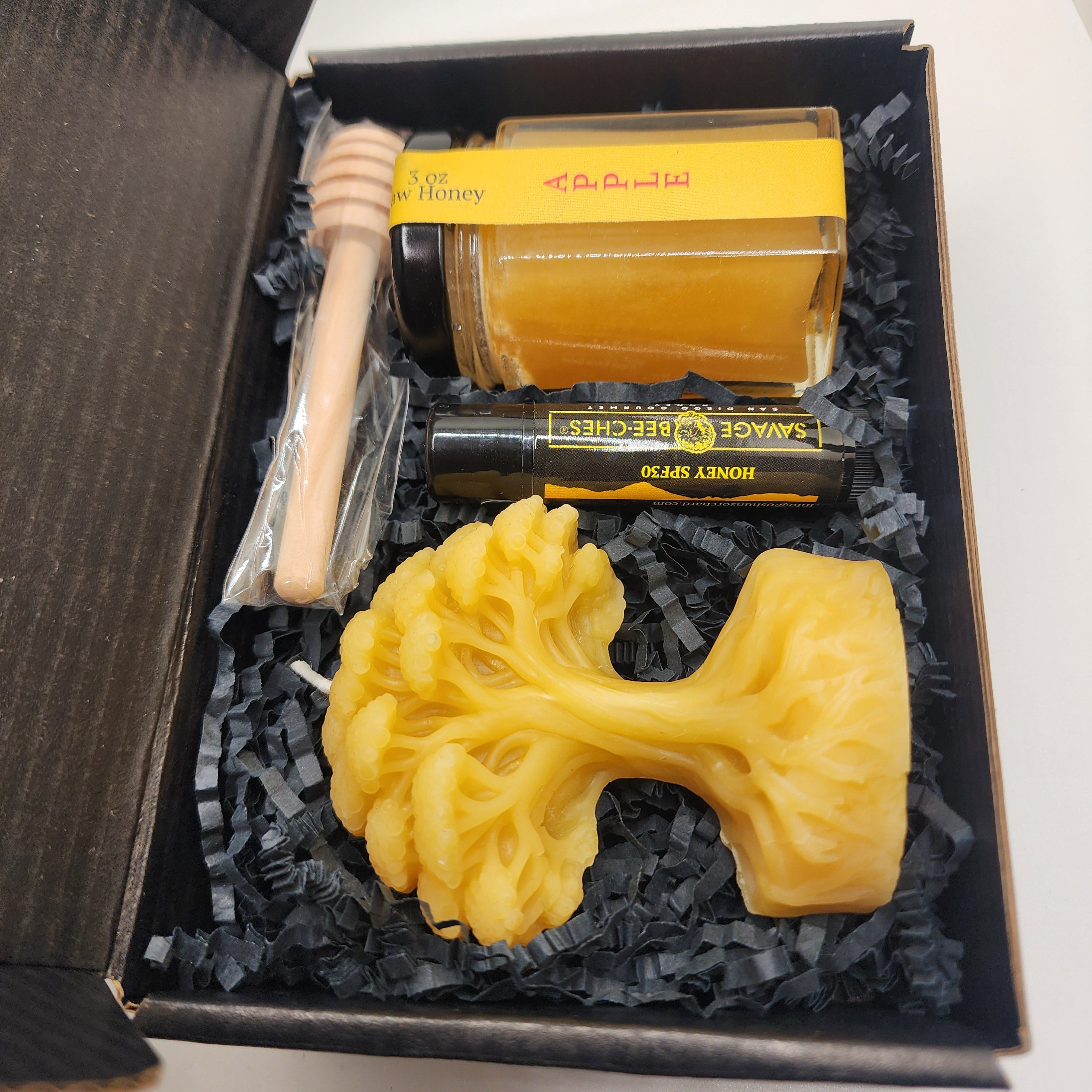 Handcrafted honey and beeswax products arranged as an elegant gift set
